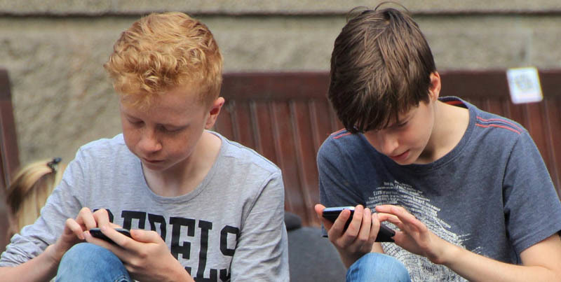 Two boys on smartphones