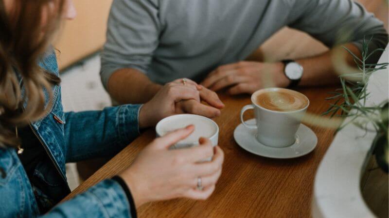 girl and guy deep conversation over coffee (1)